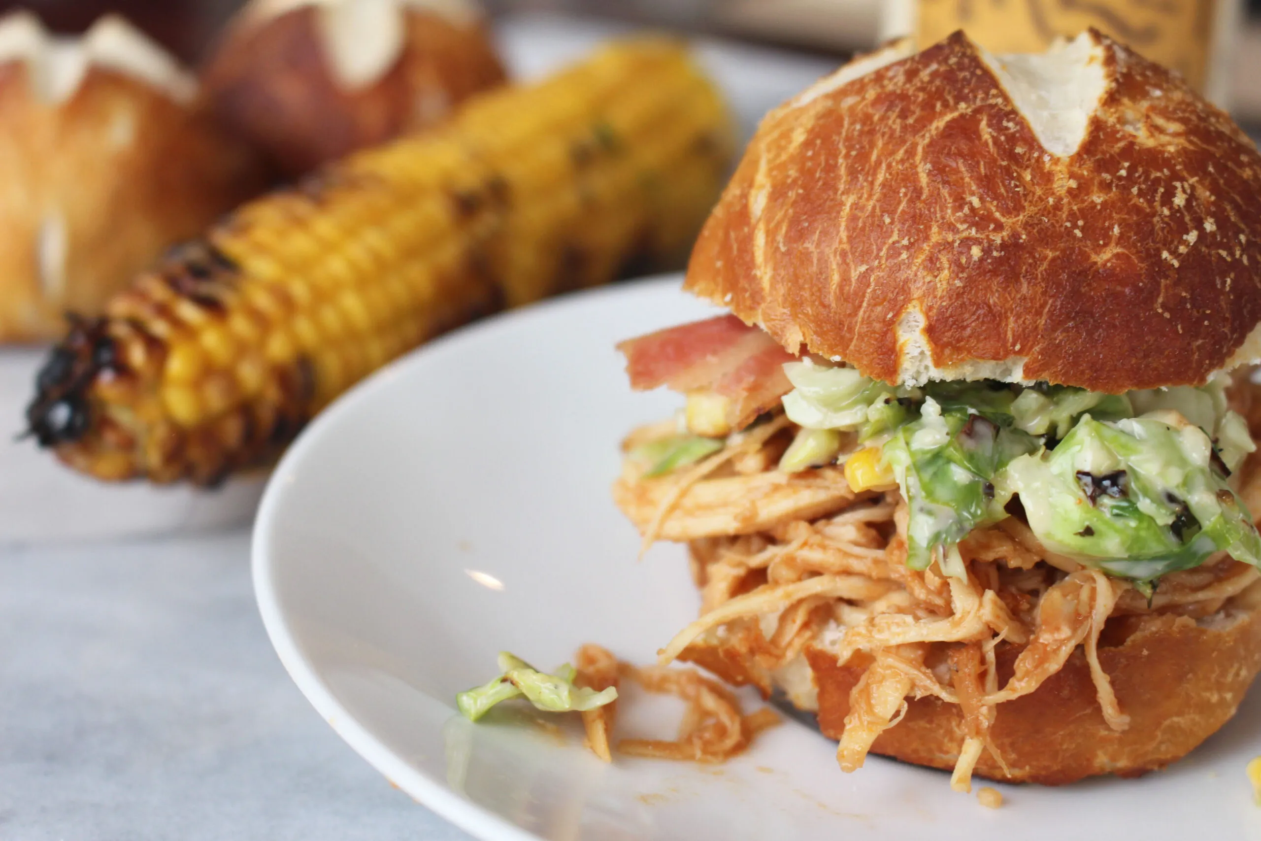 Slow Cooker Bourbon Brown Sugar Pulled Chicken Sandwiches with Bacon and Brussels Sprout Corn Slaw