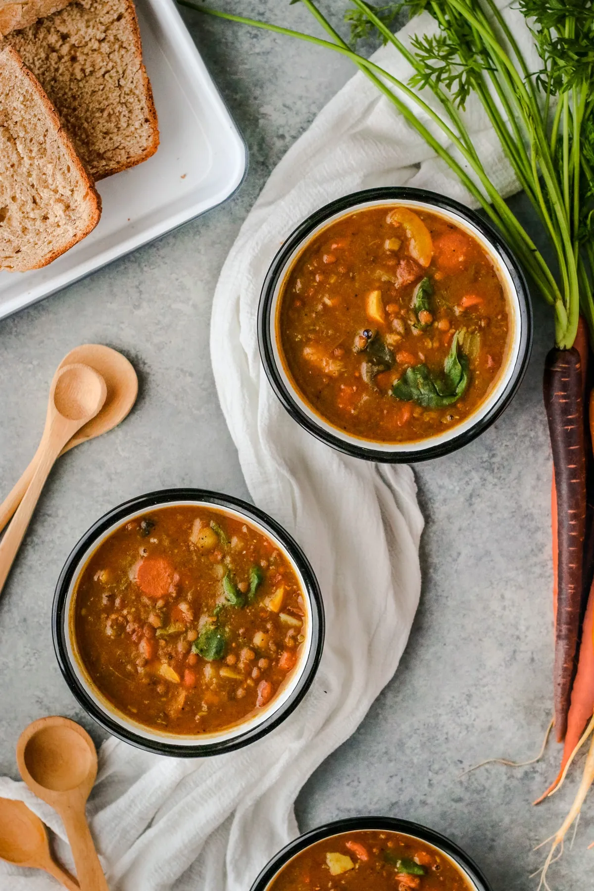 Vegan Lentil Soup with Spinach and Topped with Garlicky Almond Cream