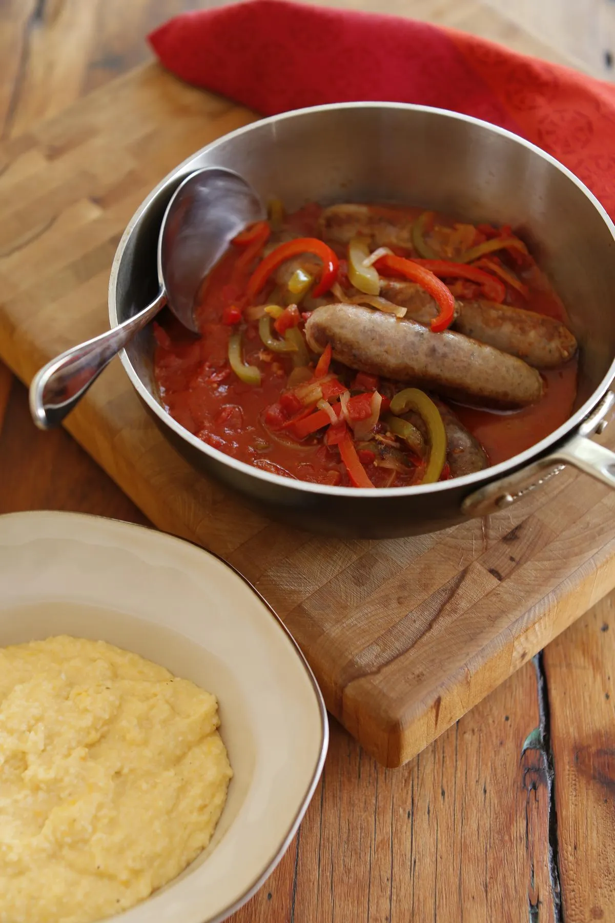 Venison Sausage Smothered in Italian Tomatoes and Onions over Cheesy Grits